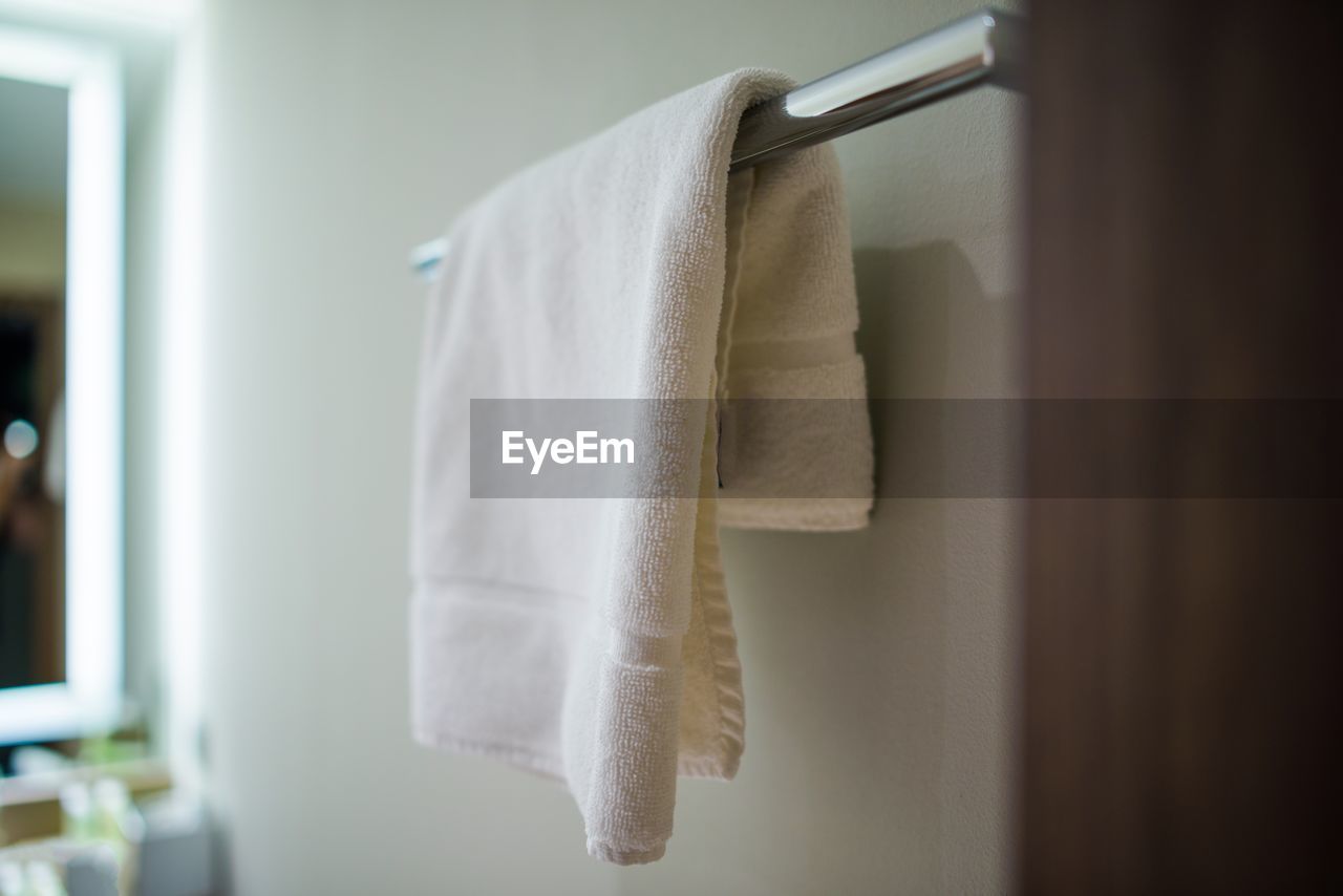 White towel hanging from metal rod in bathroom