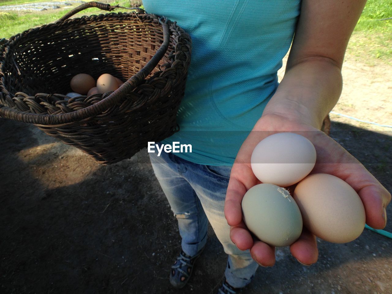 One person holding a basket with eggs