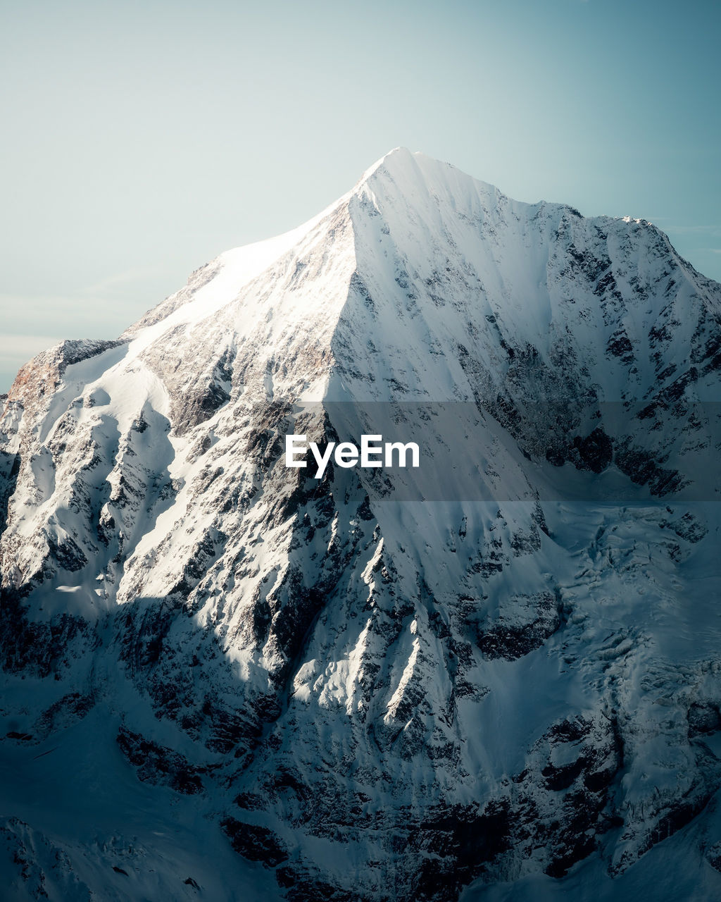 AERIAL VIEW OF SNOWCAPPED MOUNTAINS AGAINST SKY