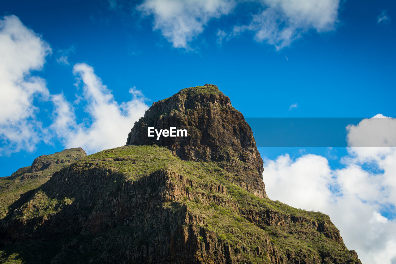 Low angle view of rock formations against sky