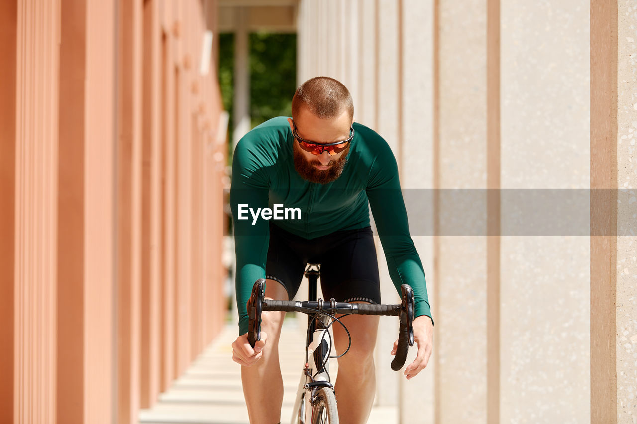 Man riding bicycle on sunny day