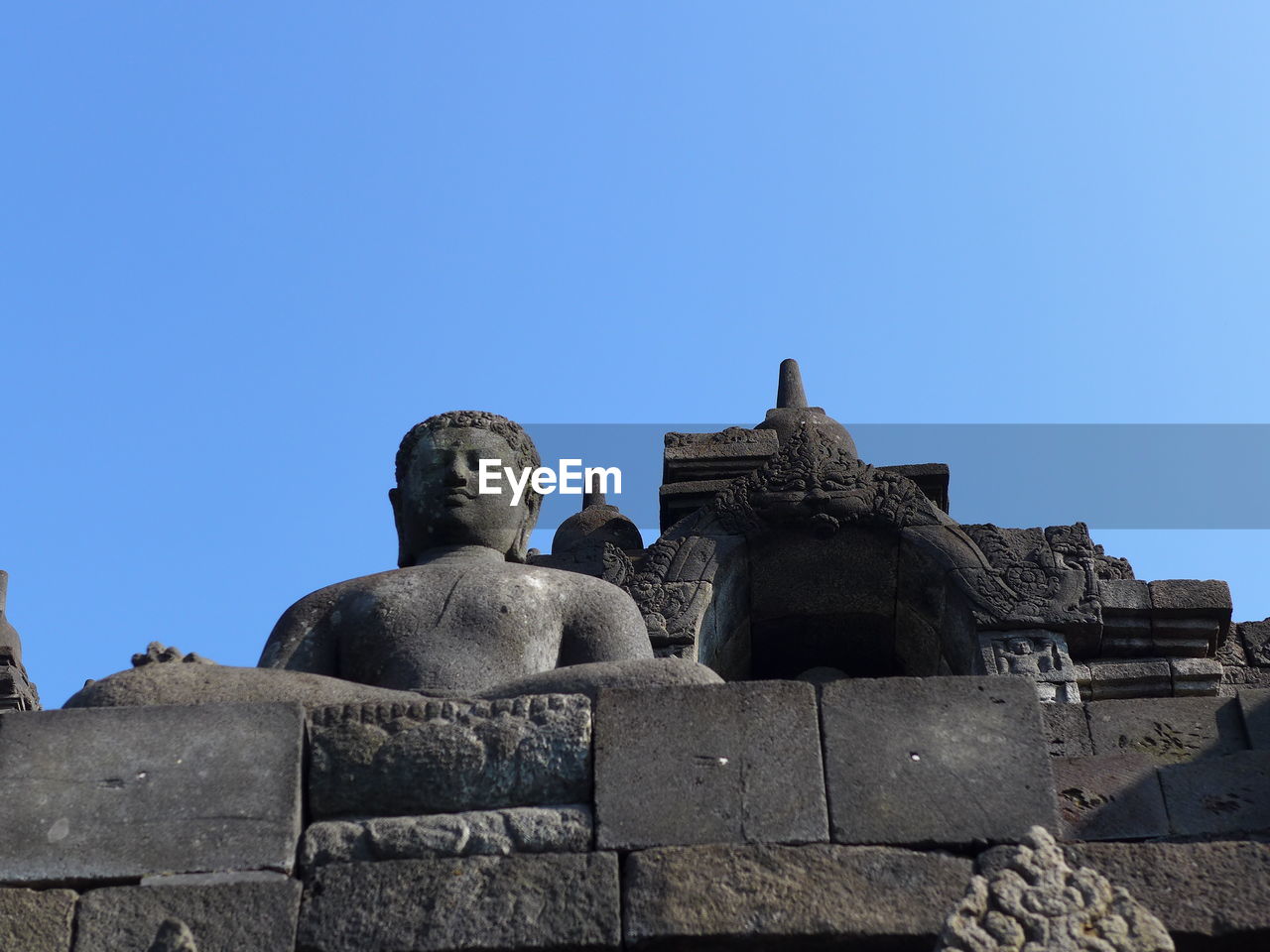 Low angle view of statue against clear blue sky in borobudur 