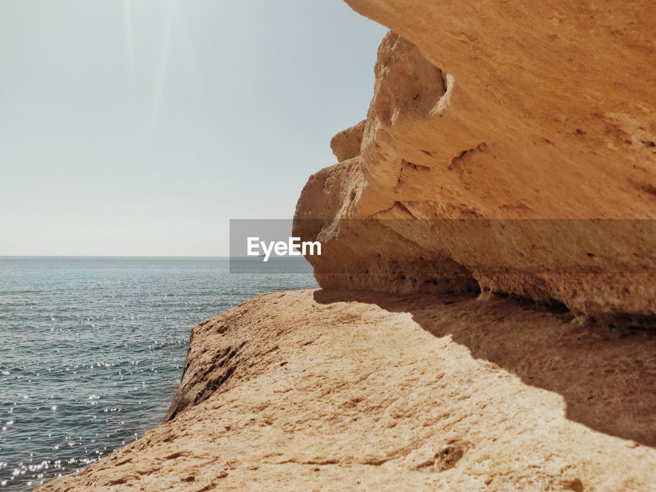 rock formations on beach against sky