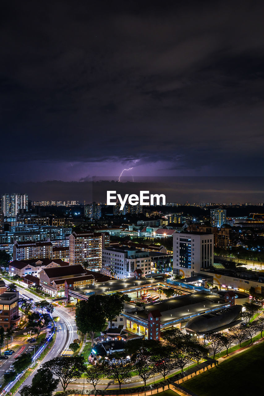 High angle view of illuminated cityscape against sky at night