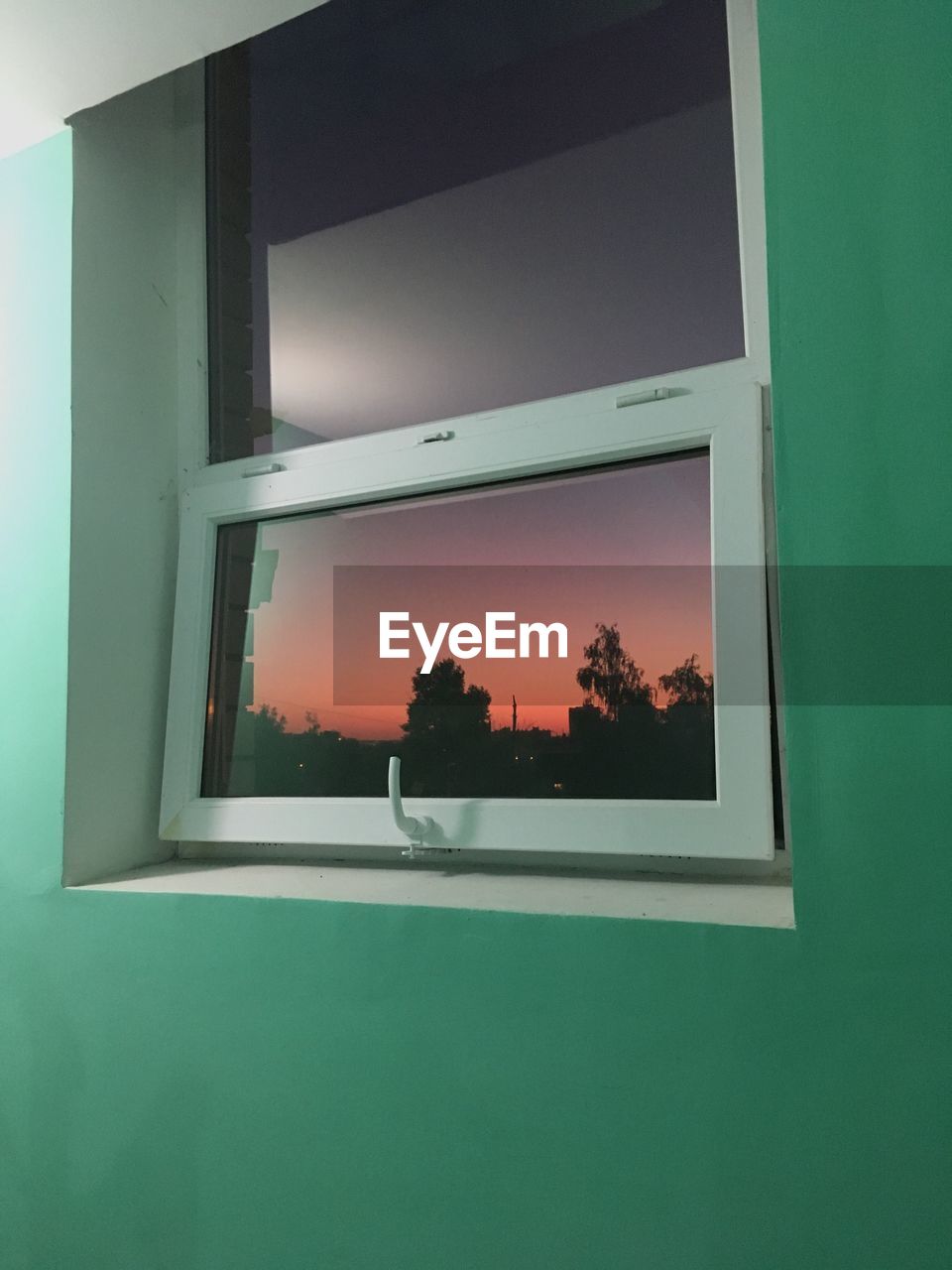 REFLECTION OF SKY ON GLASS WINDOW OF BUILDING