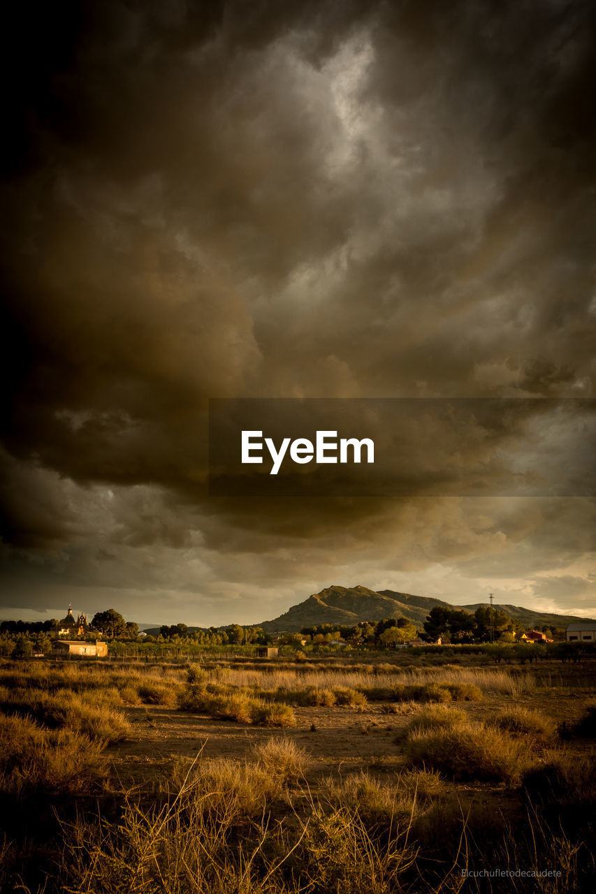 Scenic view of landscape against cloudy sky