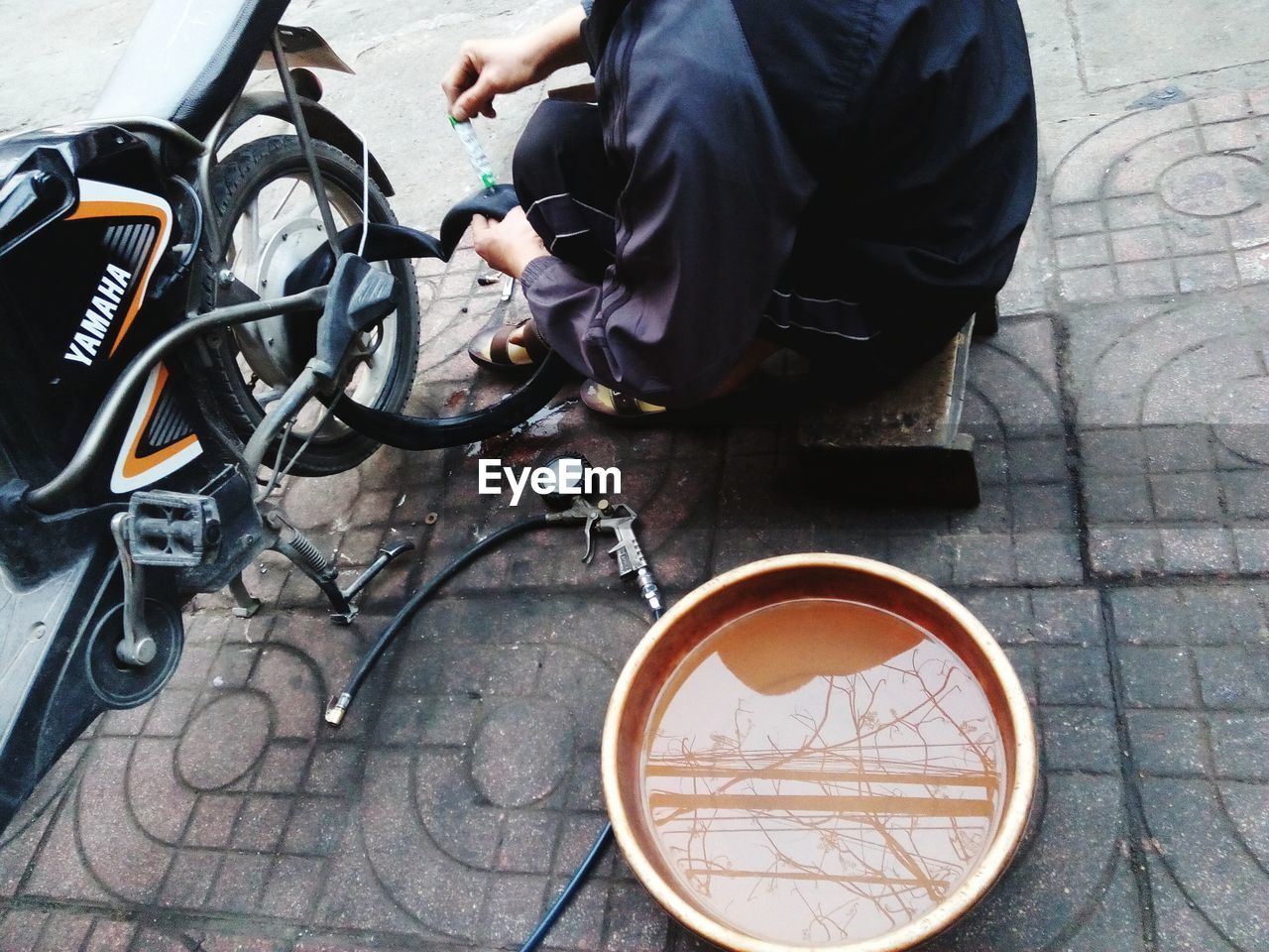 HIGH ANGLE VIEW OF MAN AND TABLE ON STREET