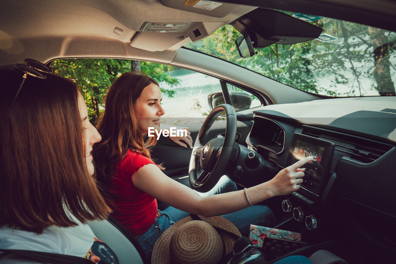 Young woman sitting in car