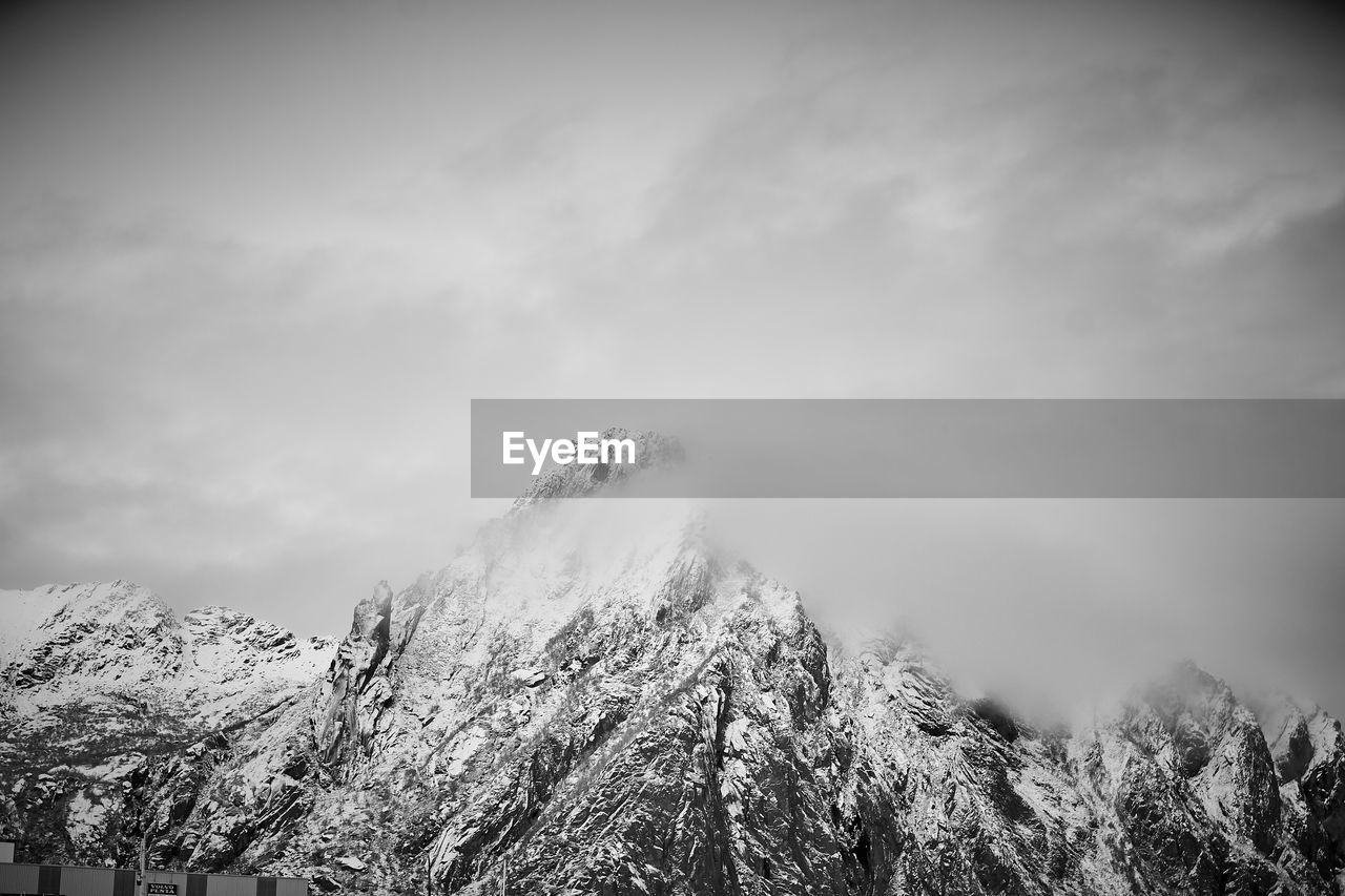 Low angle view of snowcapped mountain against sky