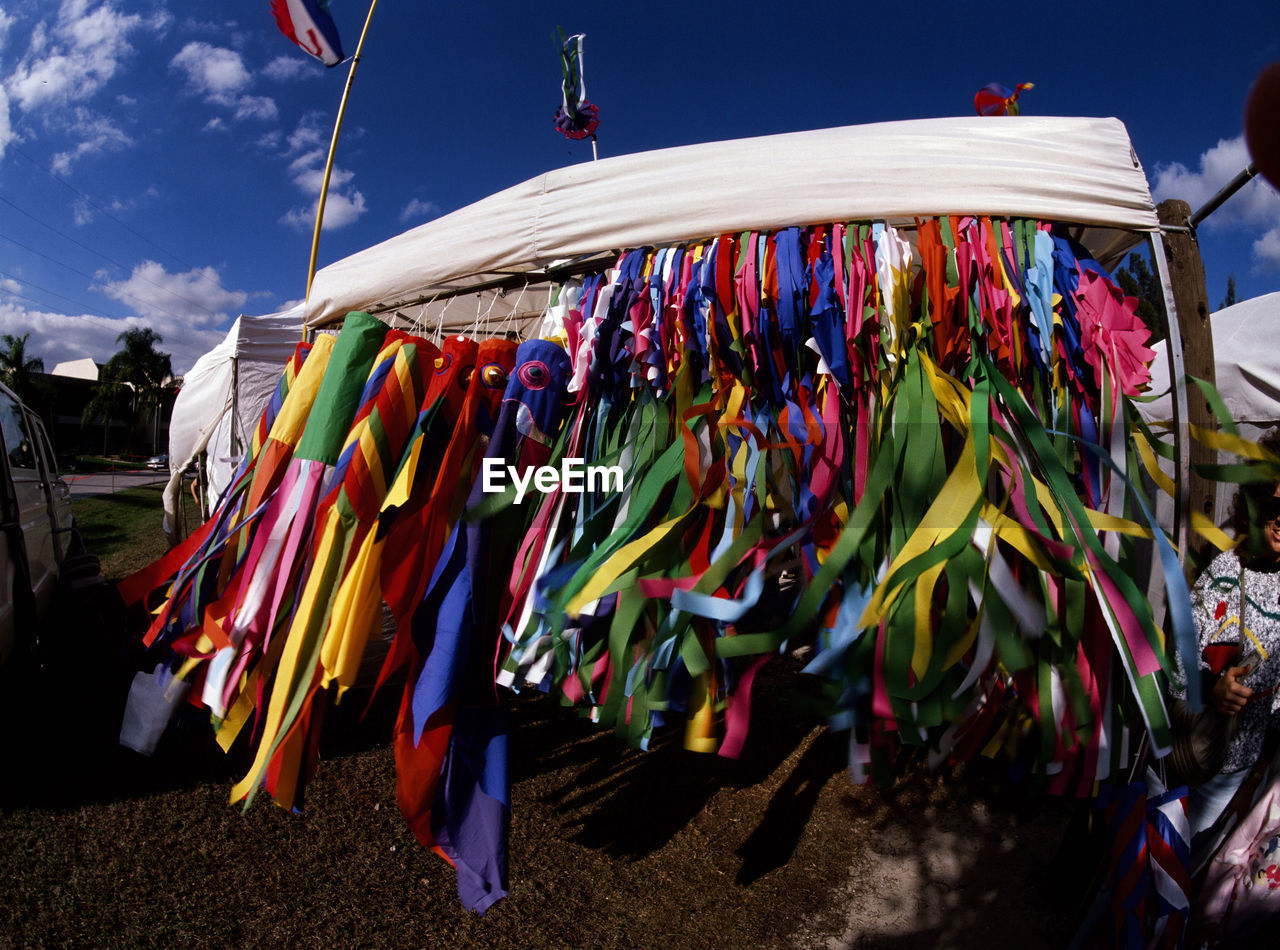 Wind socks blowing in the wind at a booth in a craft show