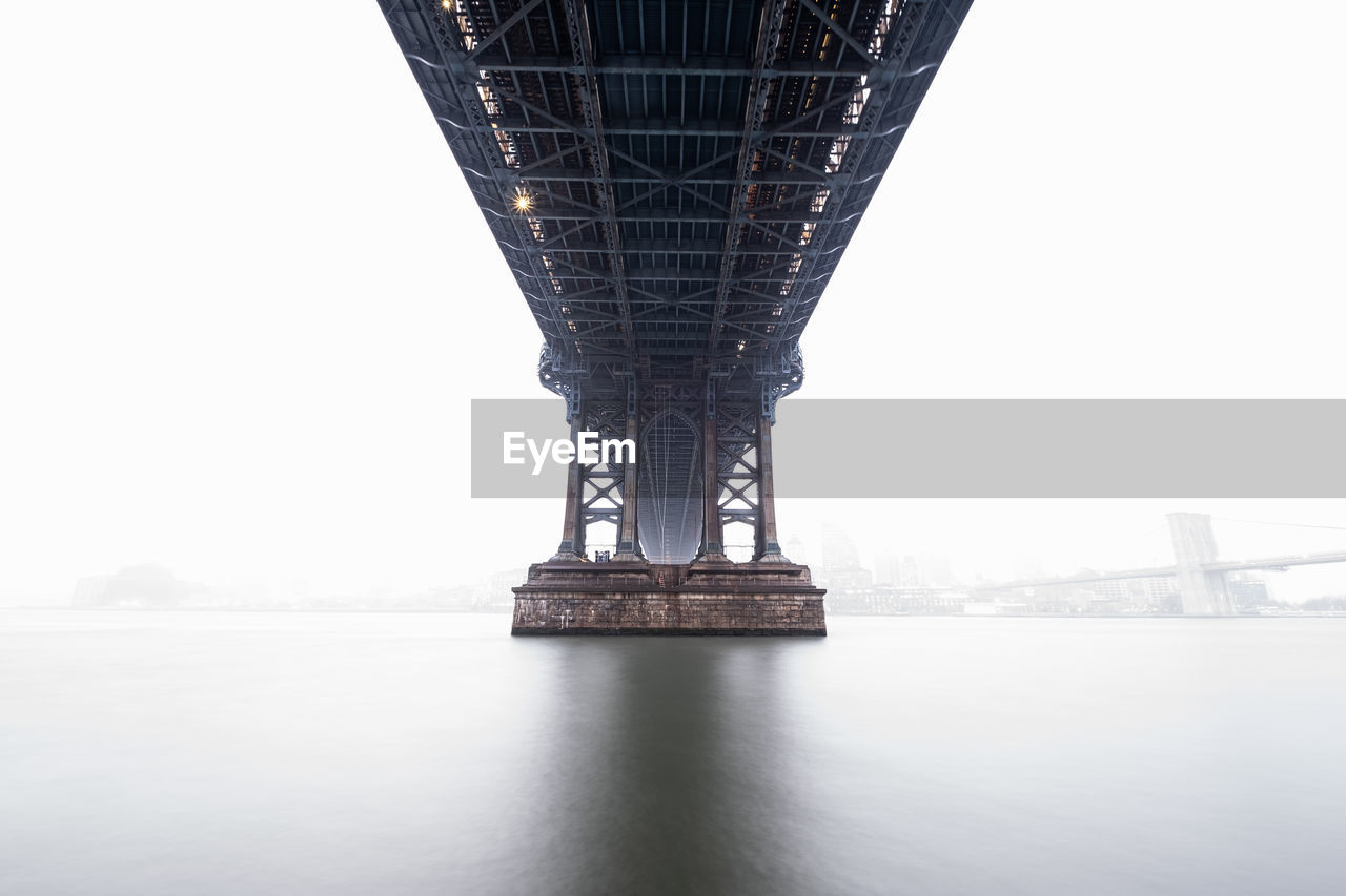 low angle view of bridge over river against sky