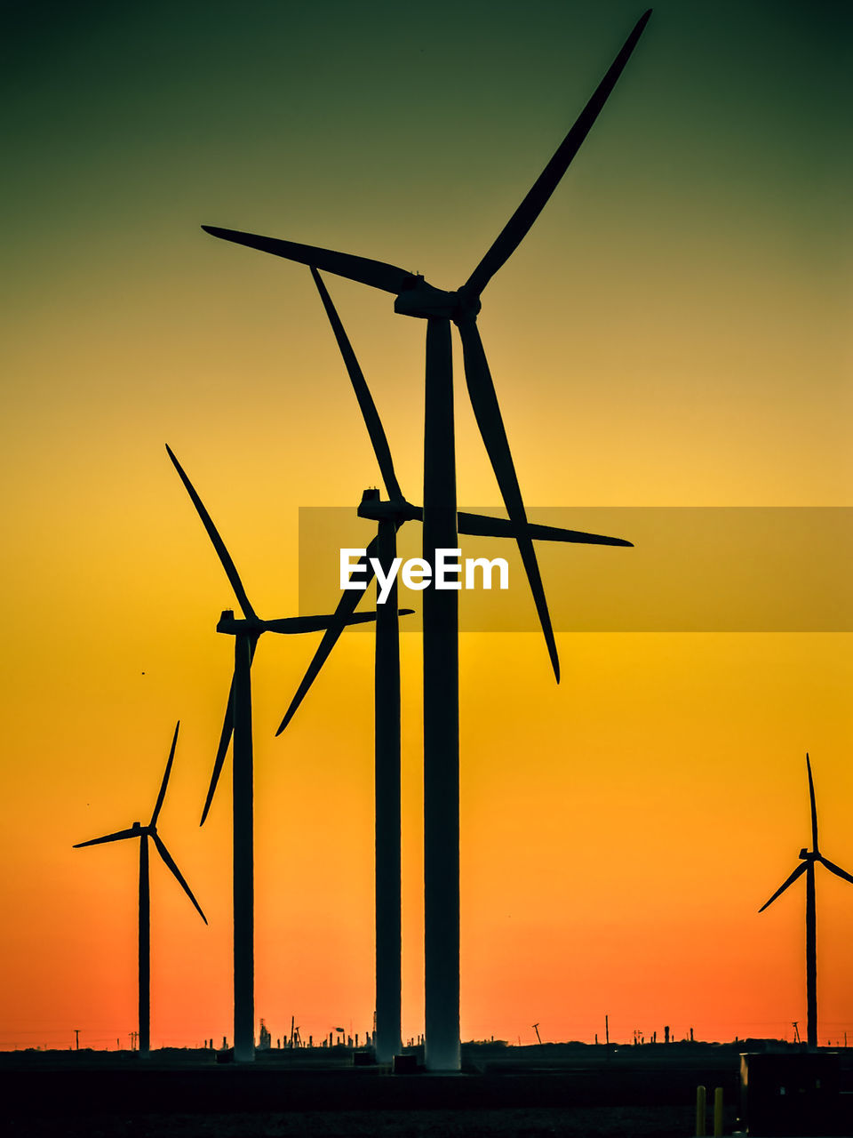 Low angle view of windmill against sky during sunset