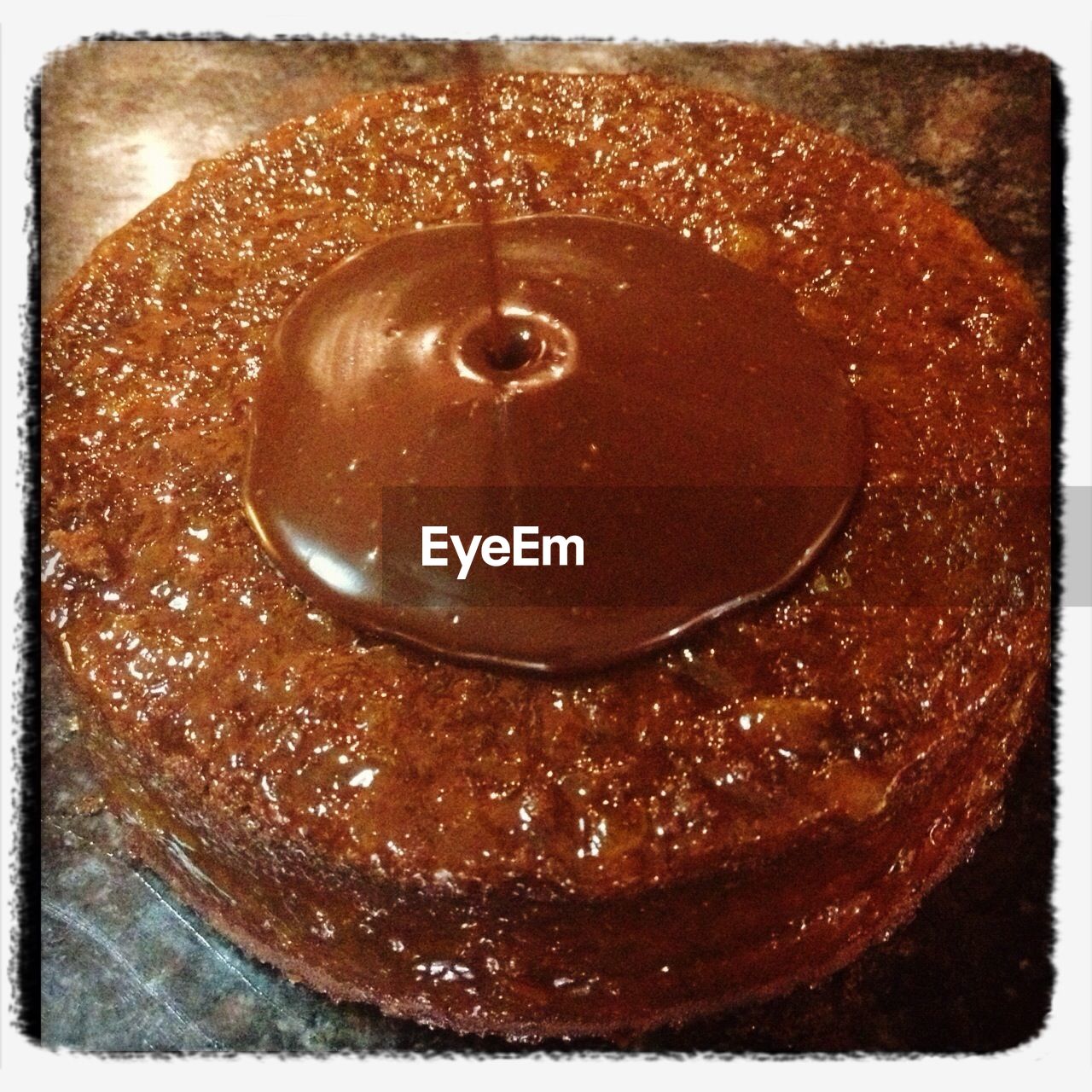 Close-up of chocolate pouring on cake