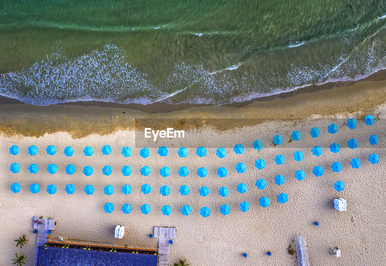 Aerial view of beach umbrella at sea shore