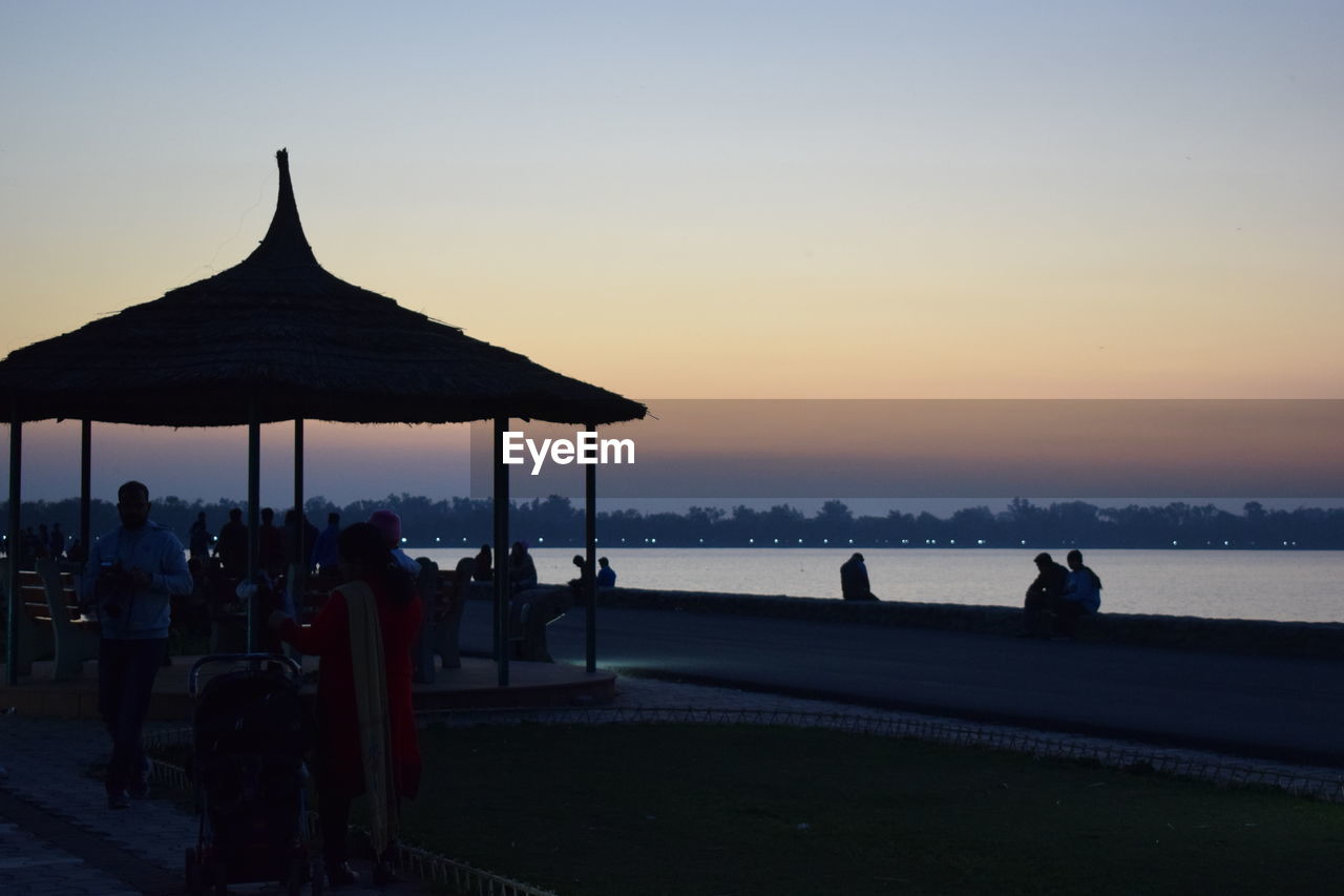 SILHOUETTE PEOPLE ON BEACH DURING SUNSET