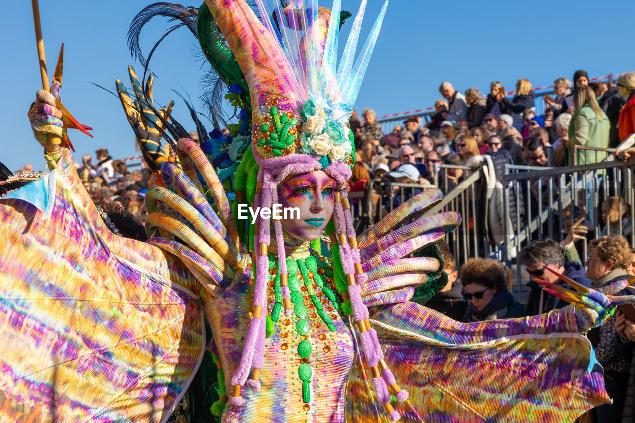 celebration, tradition, carnival, multi colored, event, arts culture and entertainment, group of people, festival, crowd, adult, traditional festival, dancing, sky, performance, large group of people, traditional clothing, women, day, outdoors, clothing, enjoyment, men, fun, nature, person, feather