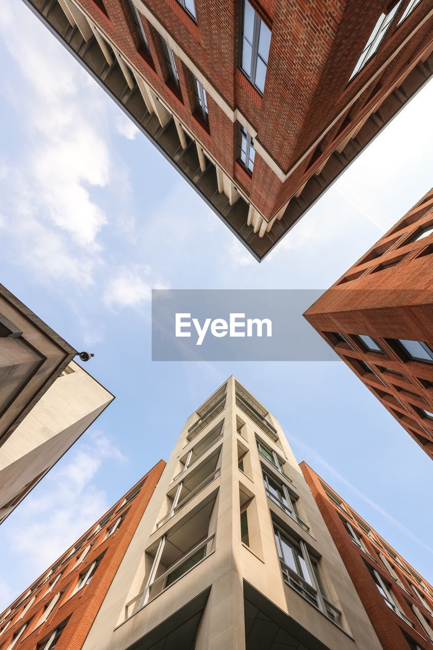 Low angle view of building against cloudy sky