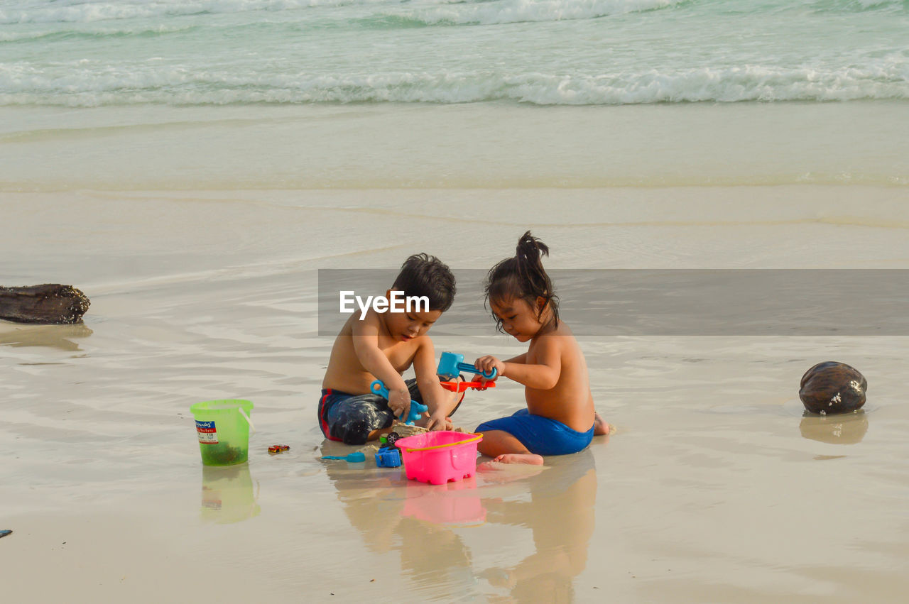Children playing with toy on beach