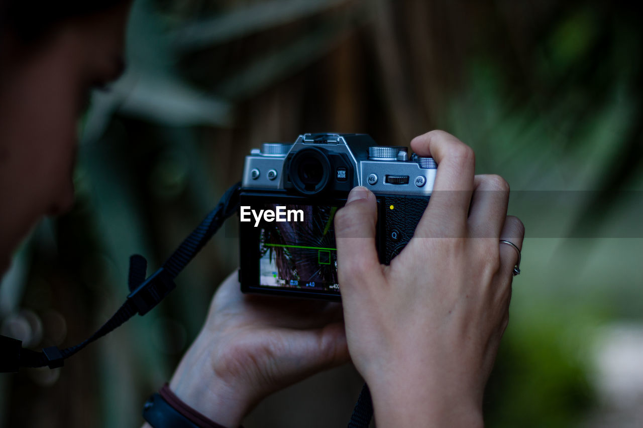 Close-up of woman photographing with camera