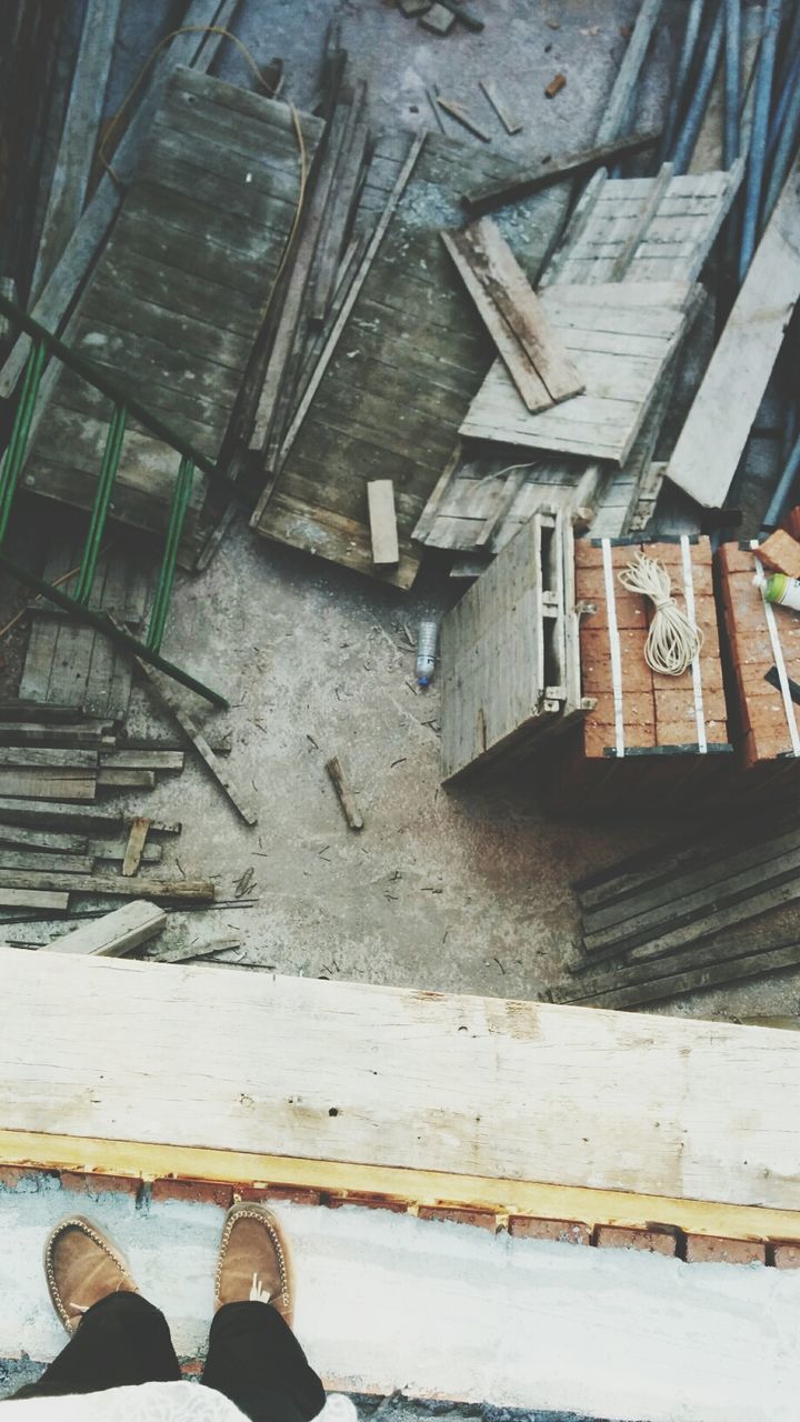 Low section of person standing at construction site