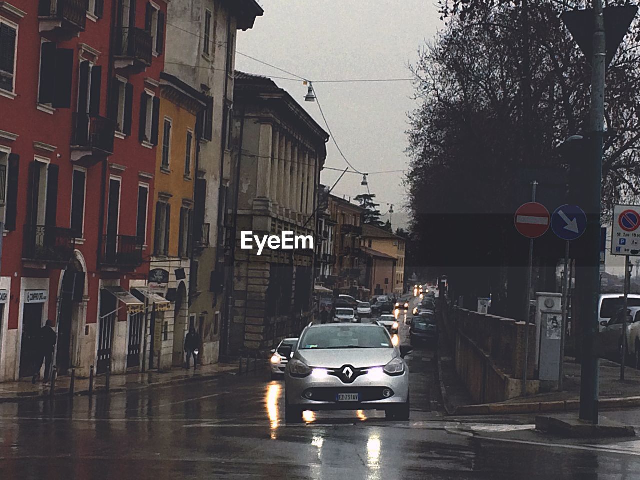 Cars moving on street by buildings