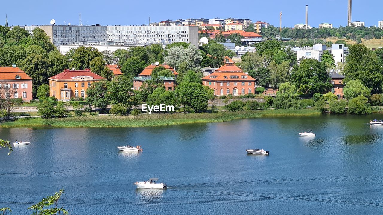 Scenic view of river by buildings in city