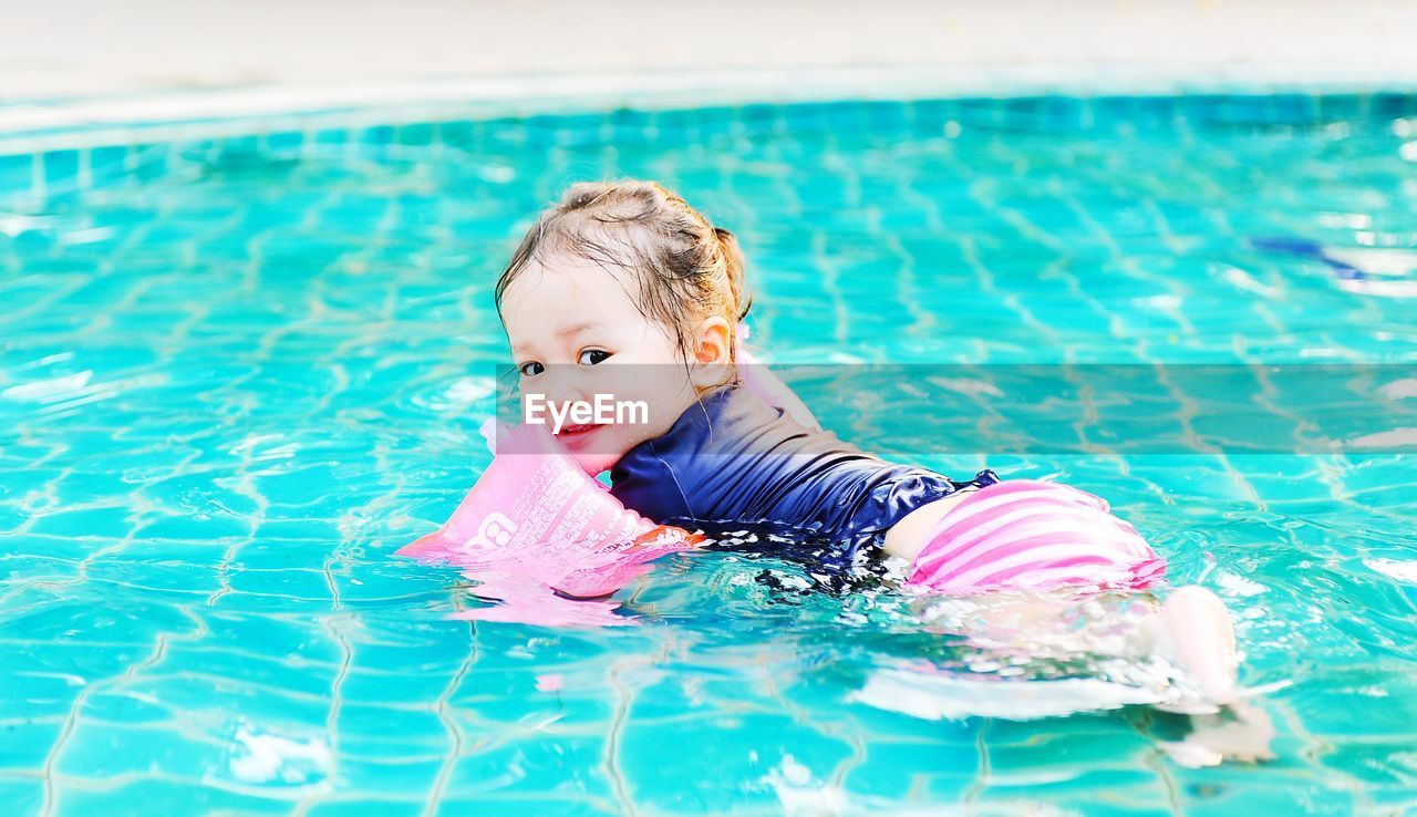 PORTRAIT OF GIRL IN SWIMMING POOL