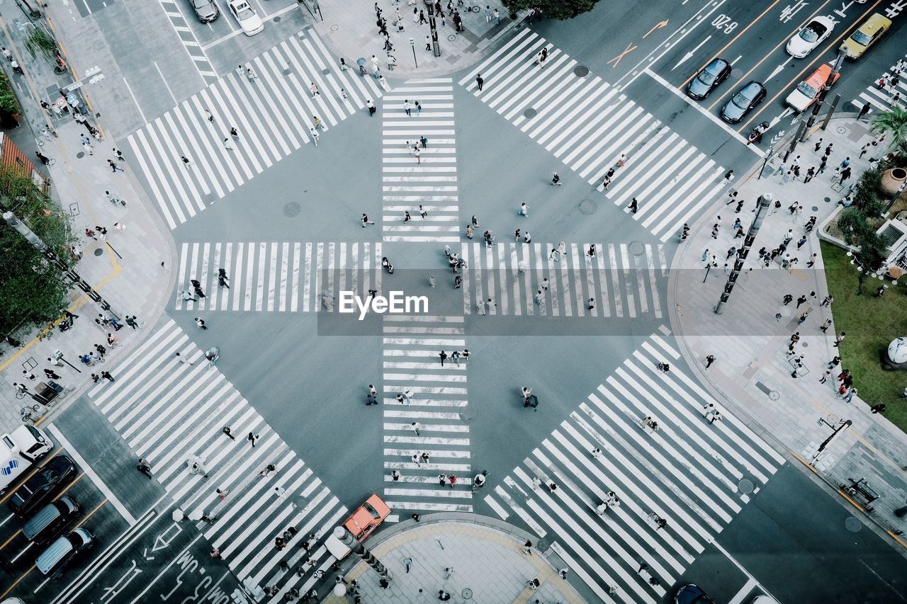 High angle view of people crossing road in city