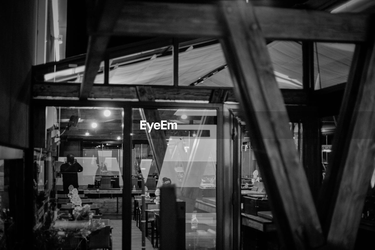 Illuminated restaurant seen through glass window