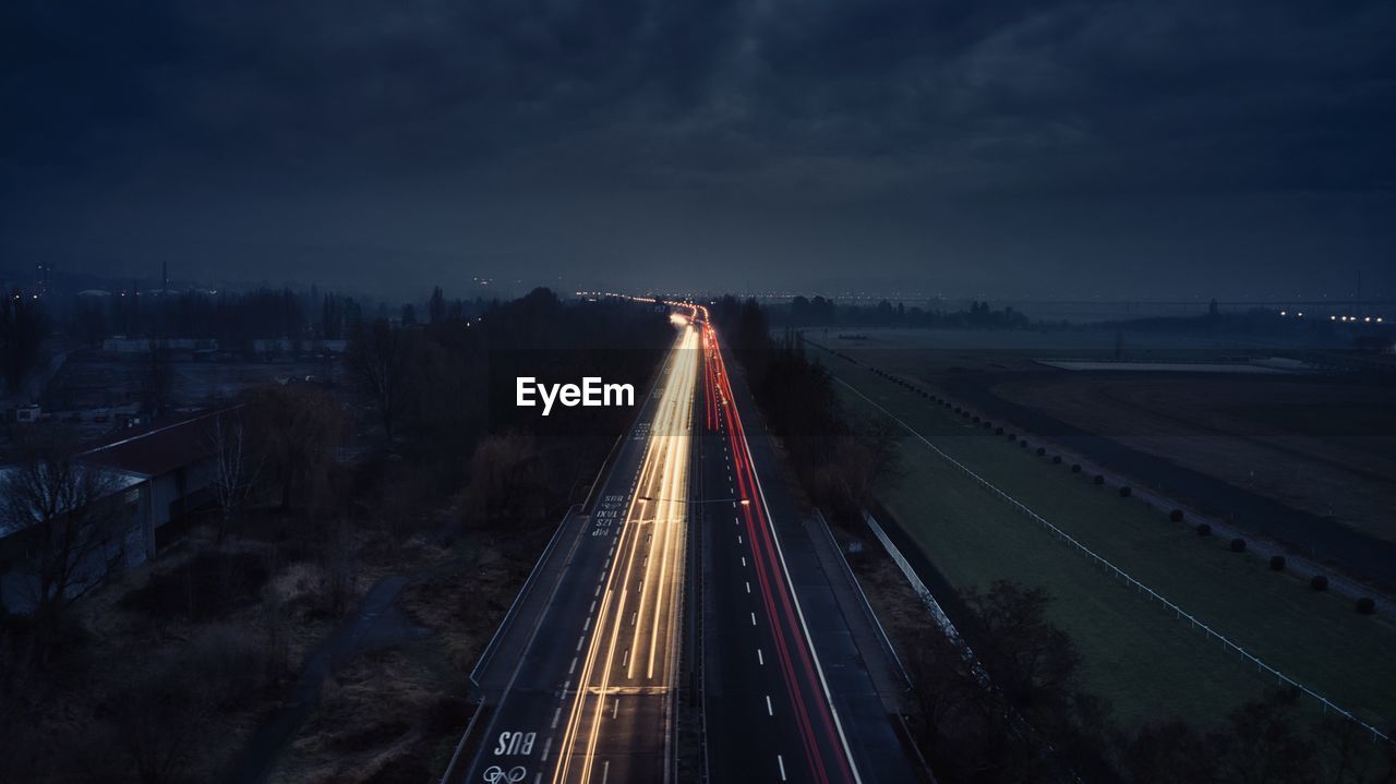 High angle view of light trails on highway at night