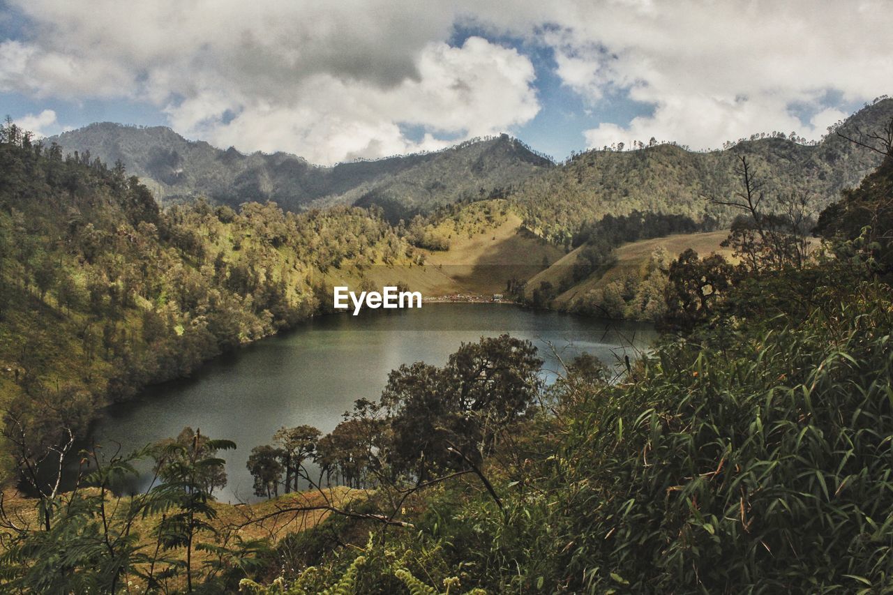 Scenic view of lake and mountains against sky