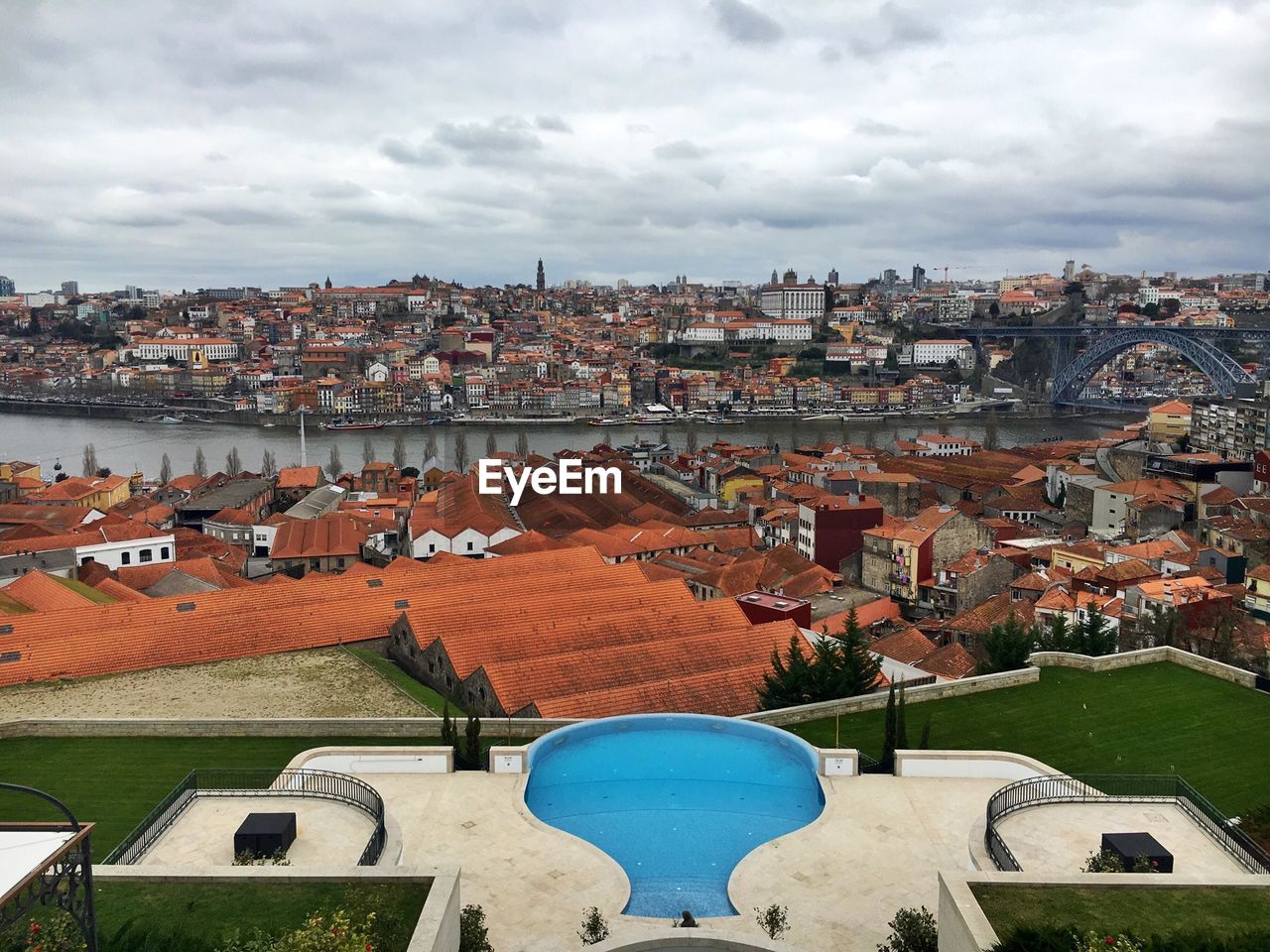 Dom luis i bridge over douro river in town against cloudy sky