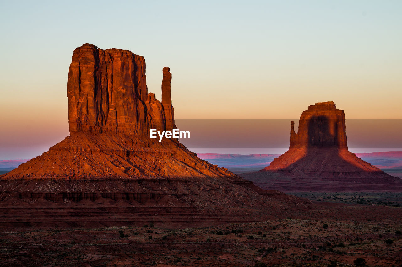 Rock formations in desert during sunset