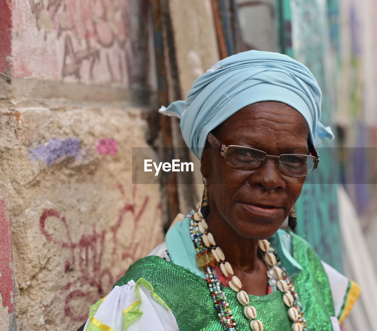 Portrait of mature woman against wall