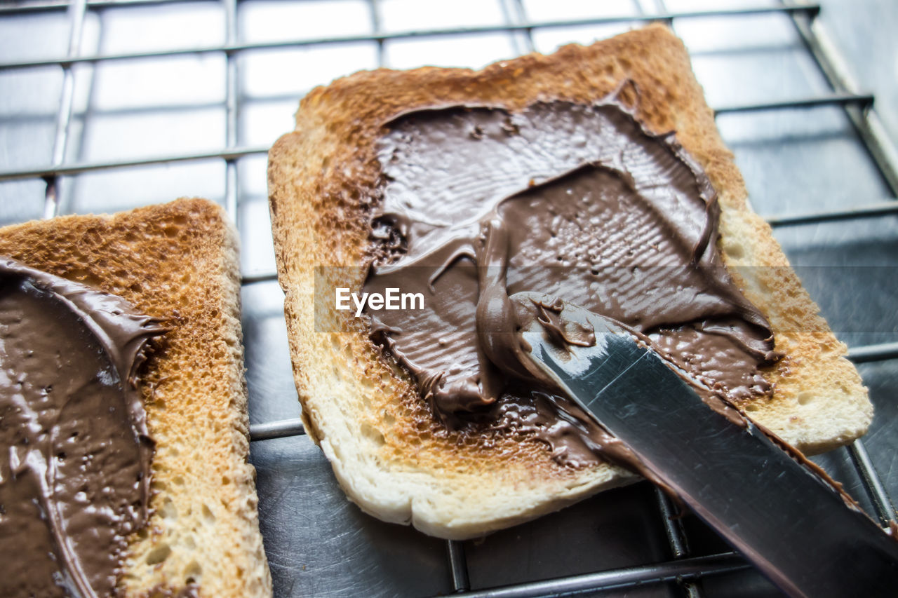 High angle view of chocolate sauce on bread slices