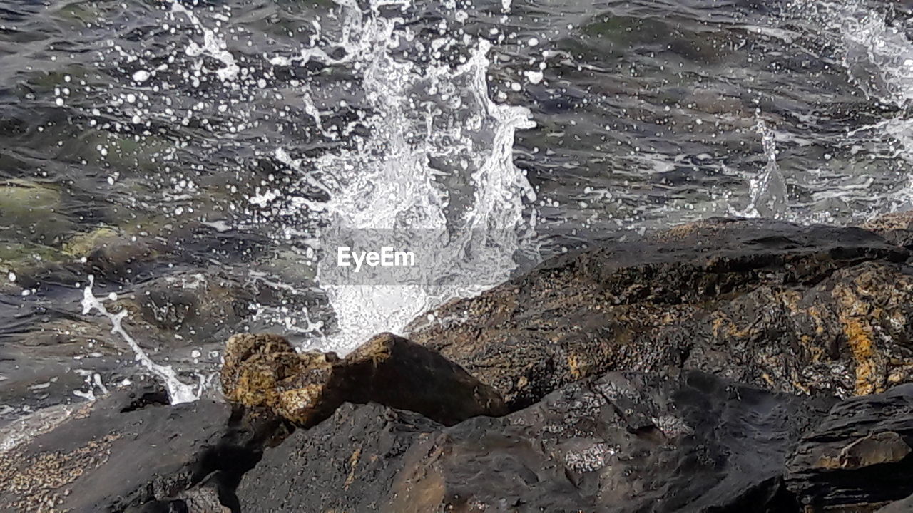 CLOSE-UP OF WAVE ON SEA