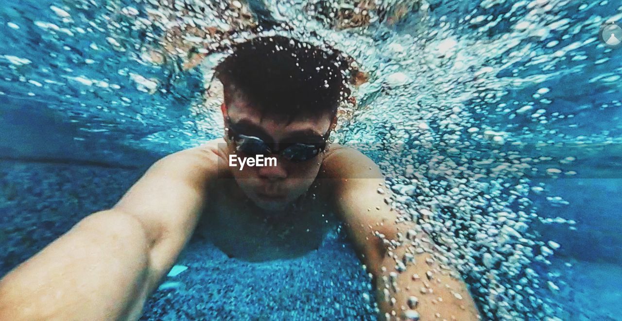 Portrait of man swimming in pool 