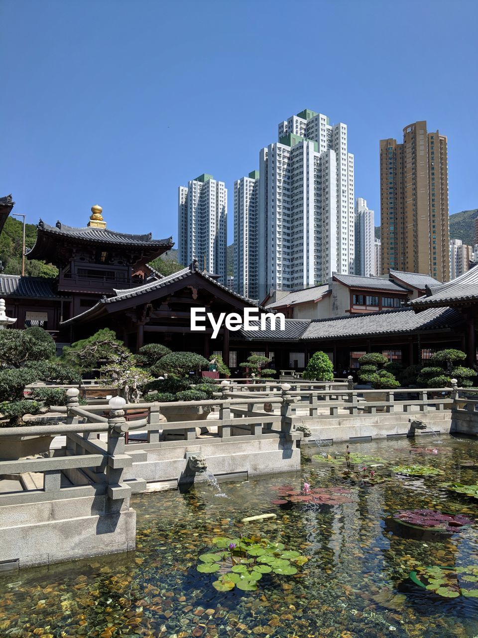 BRIDGE OVER RIVER AGAINST BUILDINGS IN CITY