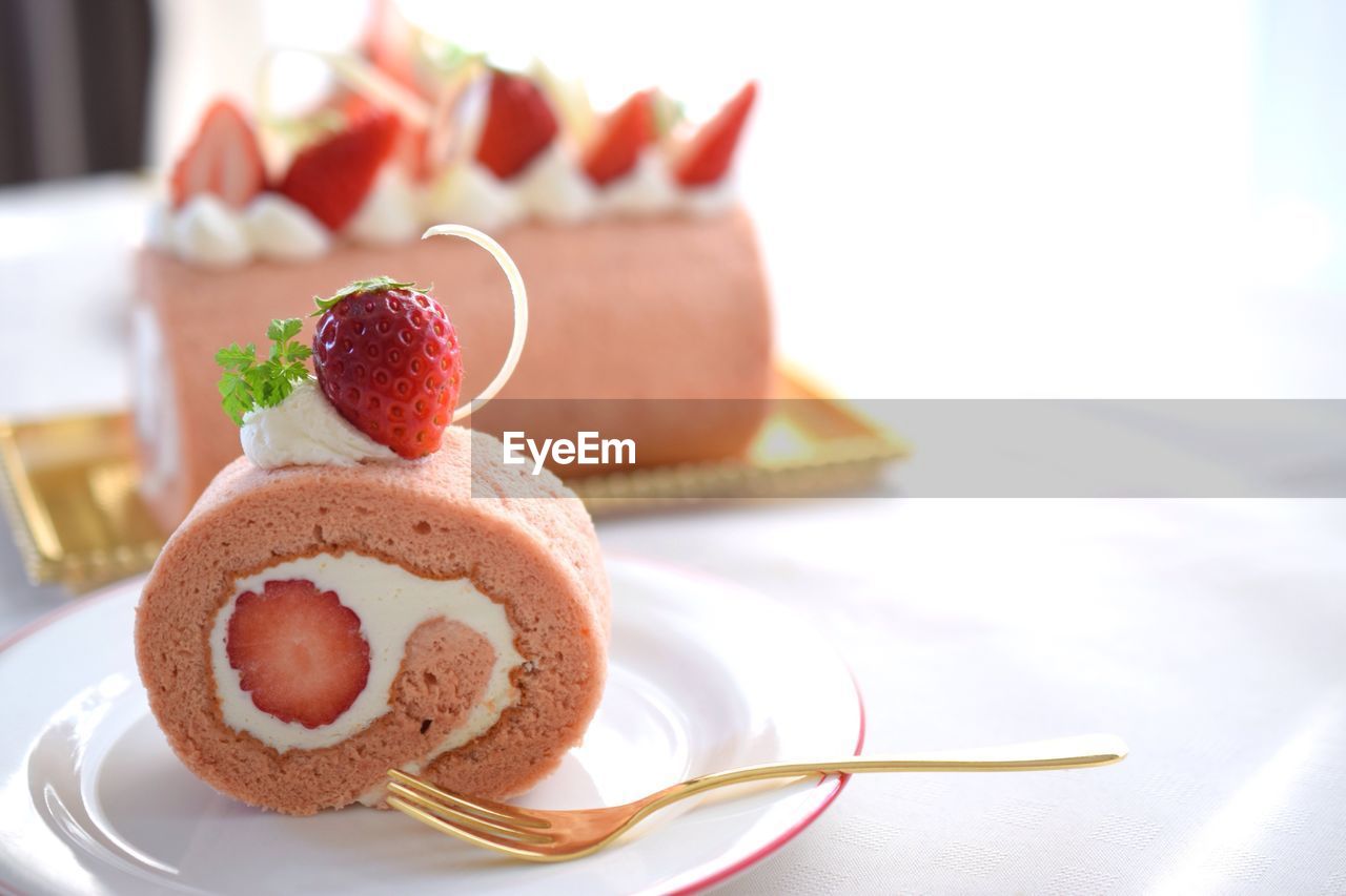 Close-up of cake with strawberry served on table