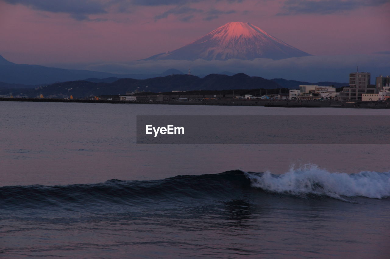 Scenic view of sea by mt fuji during sunset