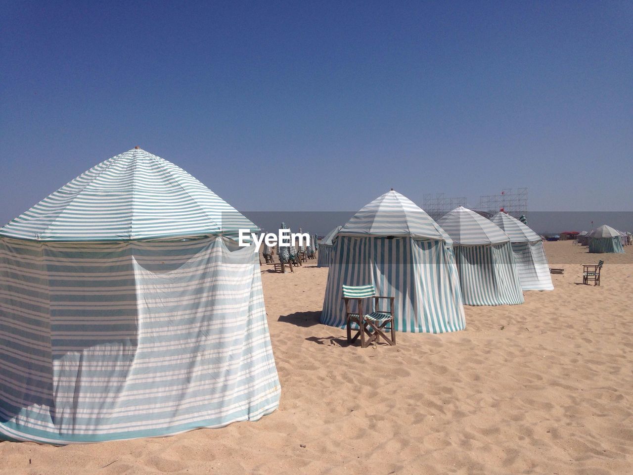 Tents on beach against clear sky