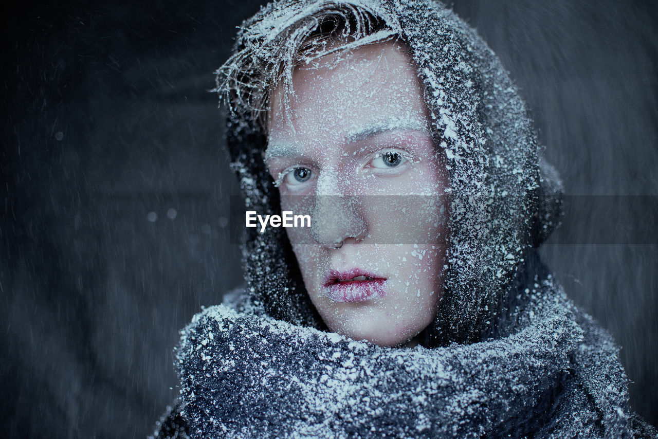 Close-up portrait of man with snow covered on face