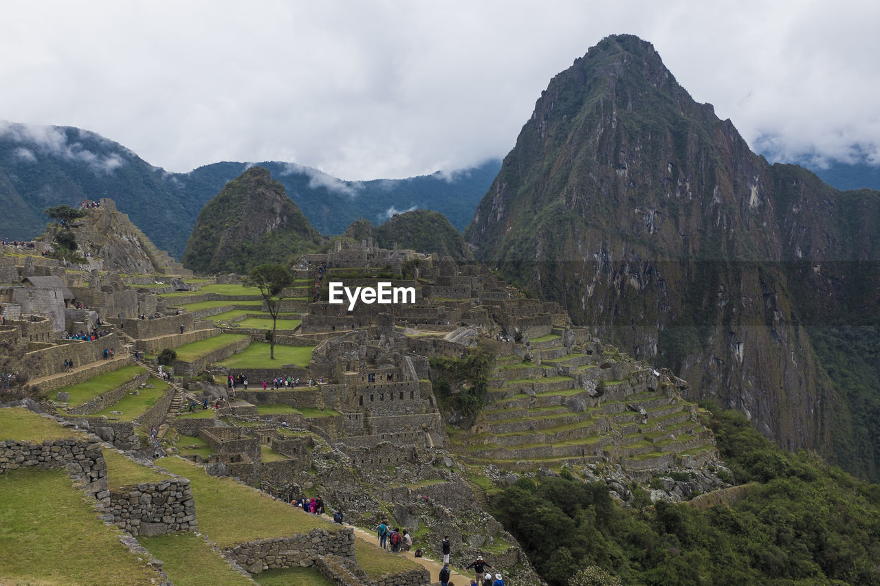 Scenic view of mountains against cloudy sky