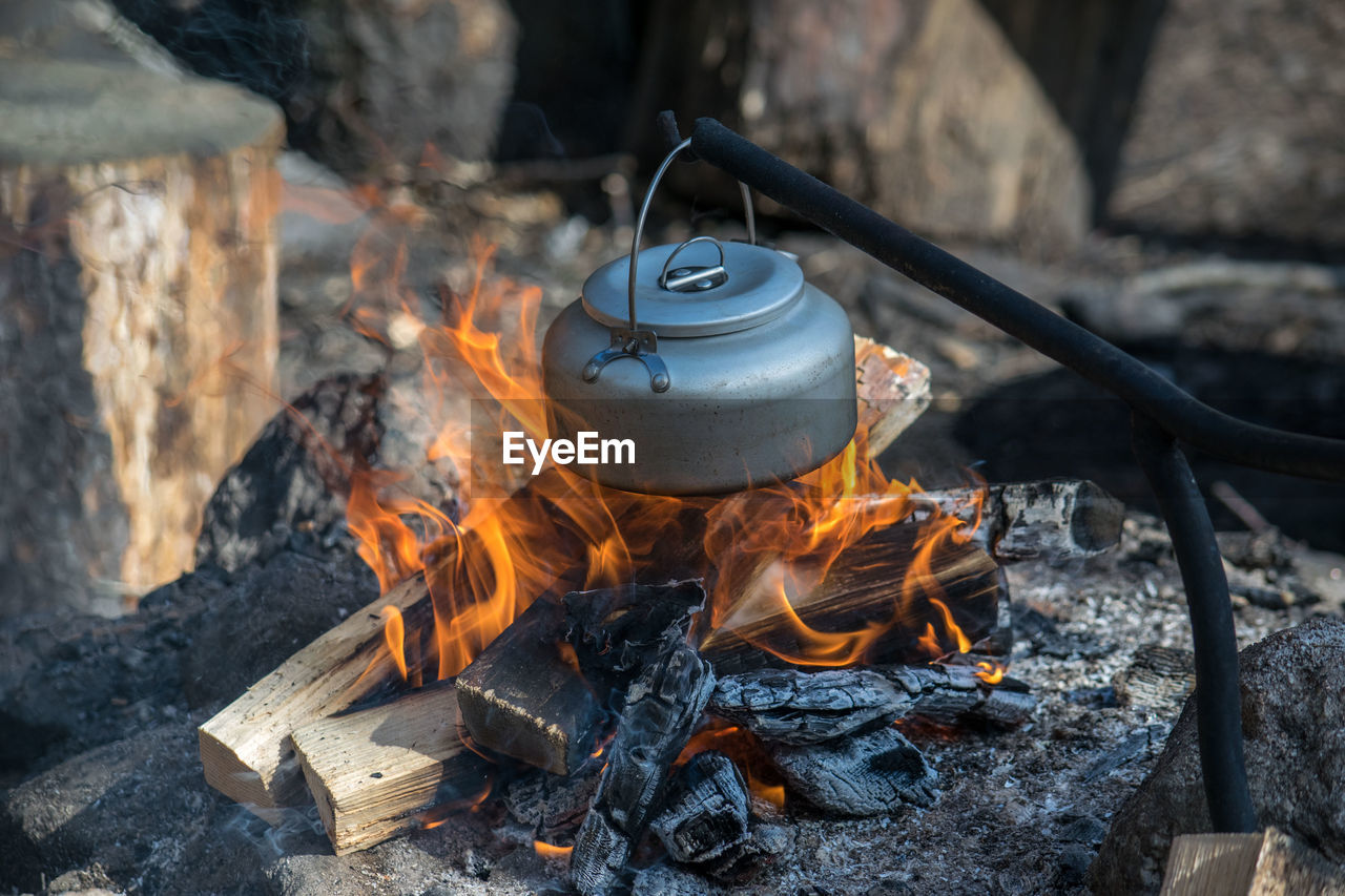 Kettle hanging over campfire