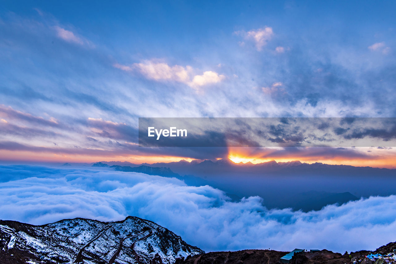 Scenic view of mountains against sky at sunset