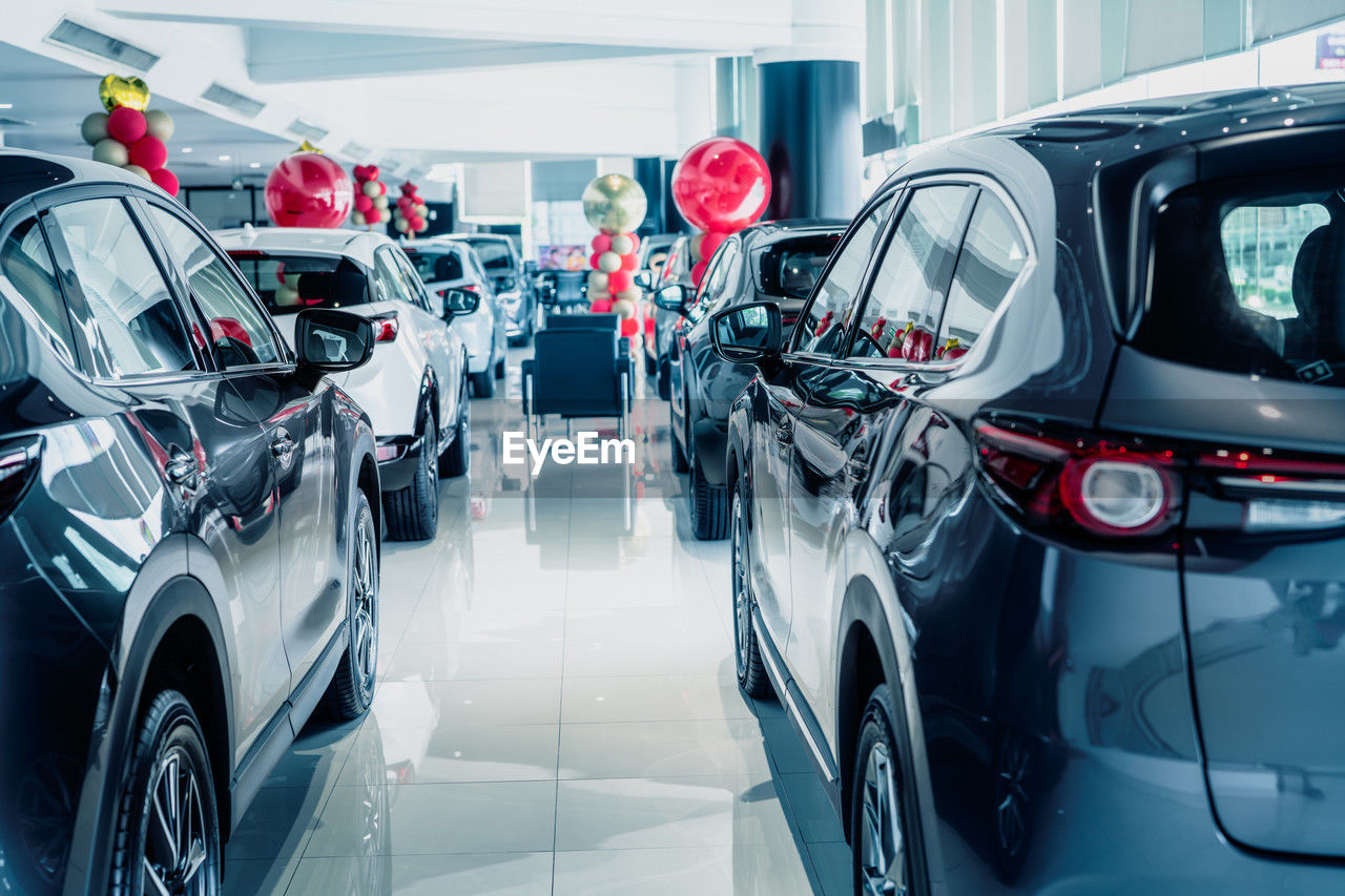 Selective focus grey car parked in luxury showroom. car dealership office. new car parked in modern