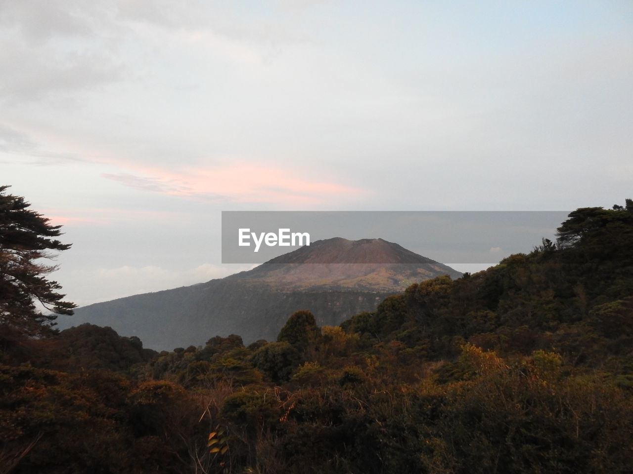 SCENIC VIEW OF MOUNTAINS AGAINST CLOUDY SKY