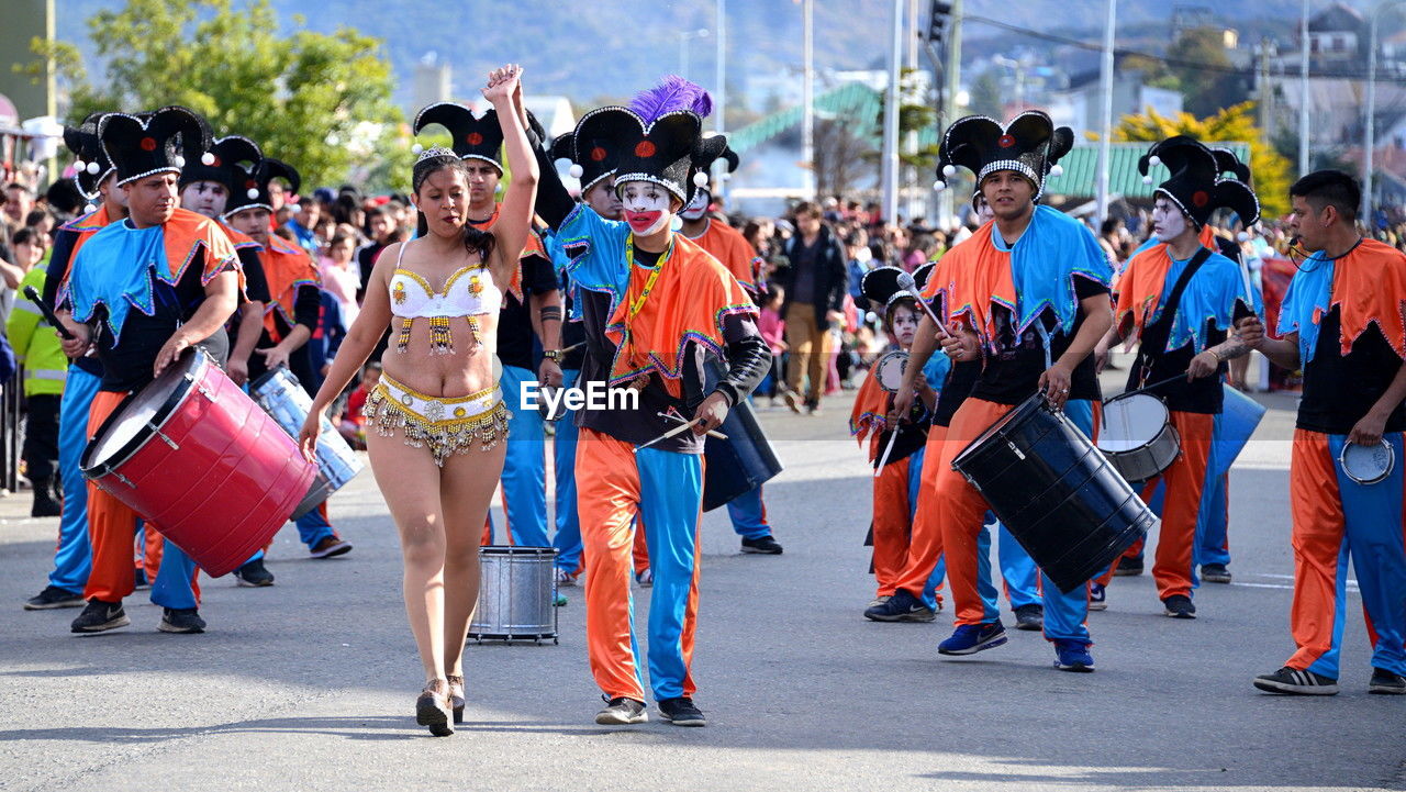 crowd, group of people, festival, large group of people, city, street, event, carnival, clothing, arts culture and entertainment, men, women, celebration, adult, architecture, parade, dancing, day, marching, performance, full length, tradition, outdoors, traditional clothing, costume, togetherness, person, social group, road
