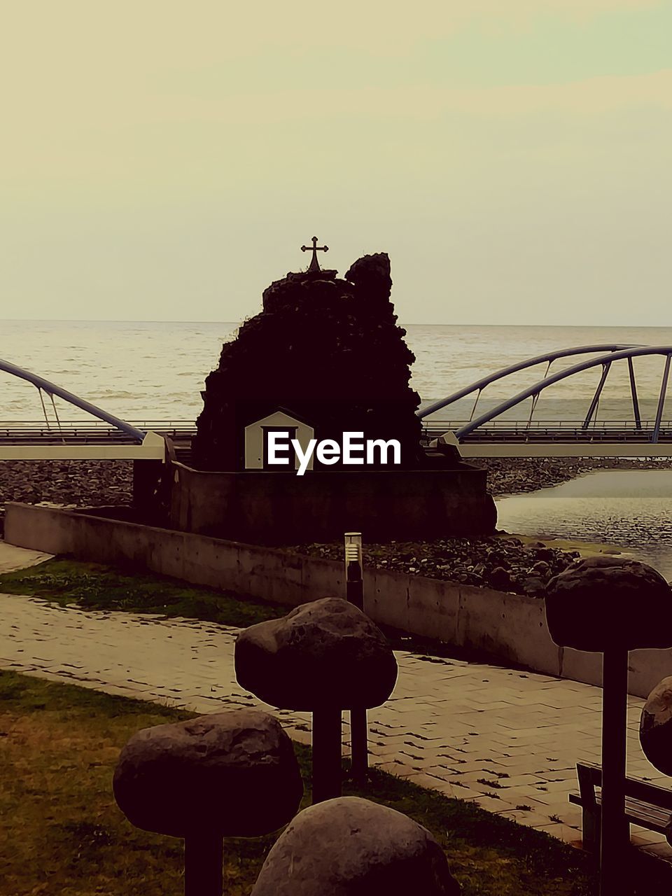 View of cross against calm sea