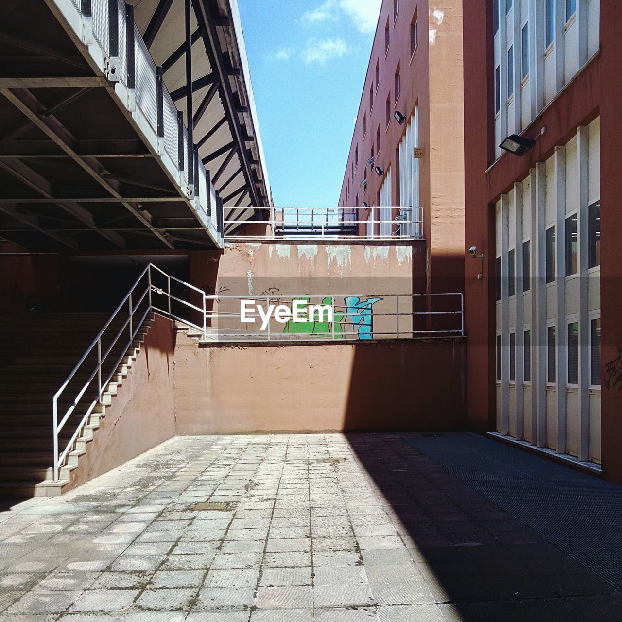 Empty alley amidst buildings in city